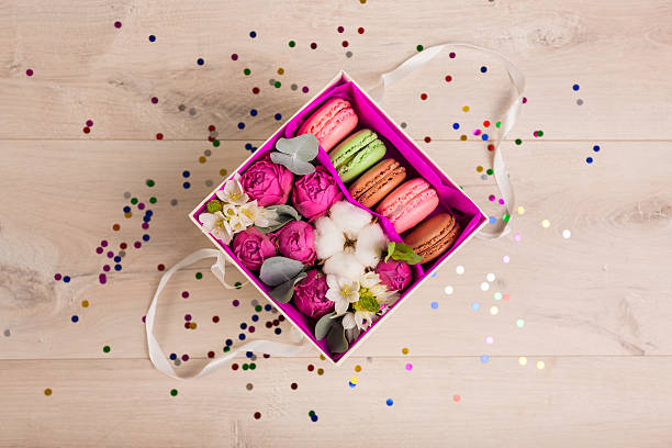 istock Flowers in a gift box and colorful confetti 621358298