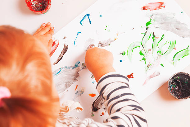 istock beautiful baby girl learning to draw 621358568