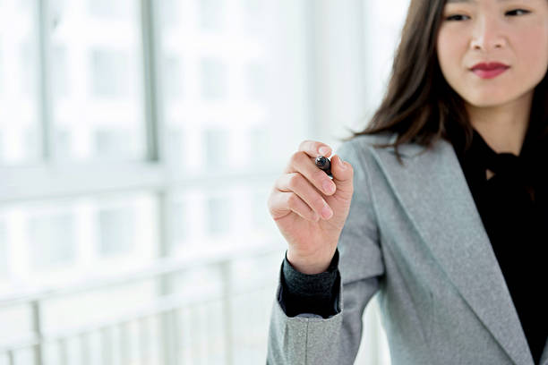 istock Businesswoman writing on empty space 621360416