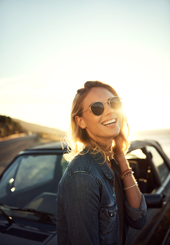 Portrait of an attractive young woman enjoying a roadtrip