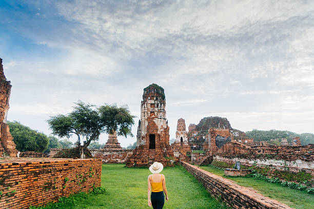 Woman walking near  ancient Buddhist Temple Young Caucasian woman walking near the ruins of ancient Buddhist Temple, Ayutthaya, Thailand ayuthaya photos stock pictures, royalty-free photos & images