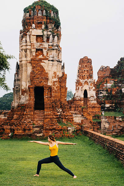 istock Woman doing yoga near ancient Buddhist Temples 621363674