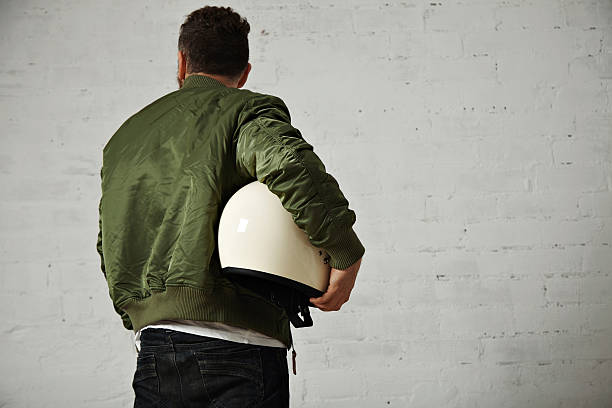 istock Man in a khaki pilot jacket with helmet 621363750