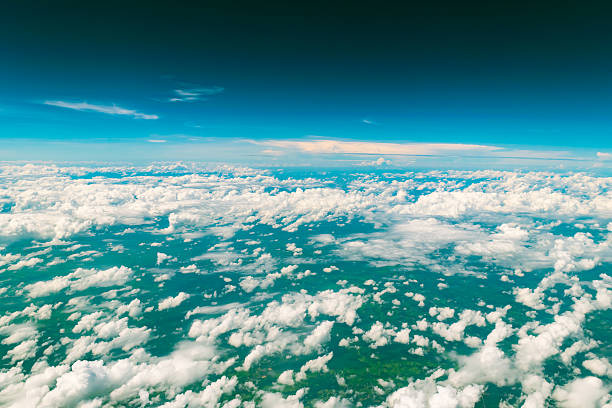 Cloud above the land Cloud above the land form window of airplane see through the land of Thailand Asia. stratosphere airplane cloudscape mountain stock pictures, royalty-free photos & images