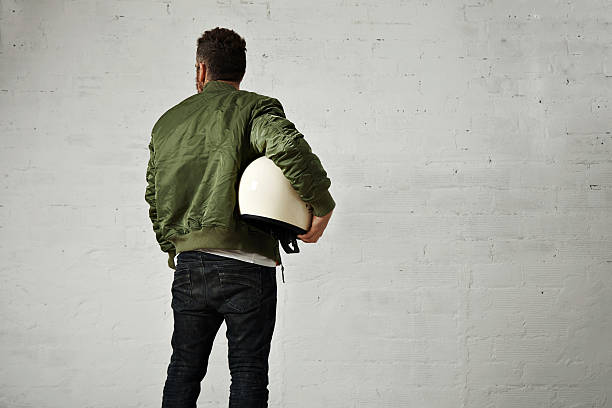 istock Man in a khaki pilot jacket with helmet 621363806