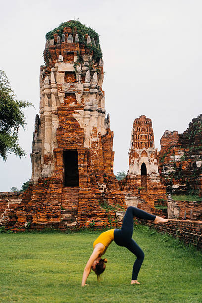istock Woman doing yoga near ancient Buddhist Temples 621363812