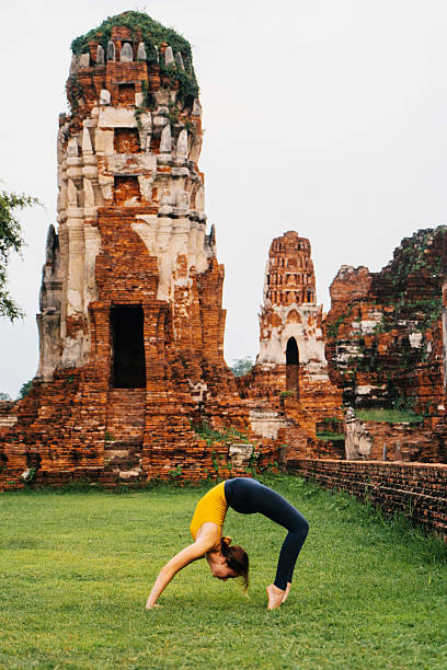 istock Woman doing yoga near ancient Buddhist Temples 621363818