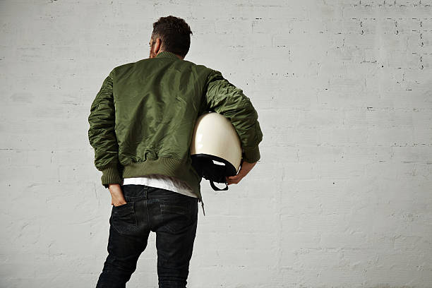 istock Man in a khaki pilot jacket with helmet 621363870