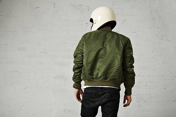 istock Man in a khaki pilot jacket with helmet 621363930