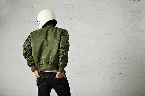 istock Man in a khaki pilot jacket with helmet 621363978
