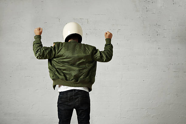 istock Man in a khaki pilot jacket with helmet 621364036