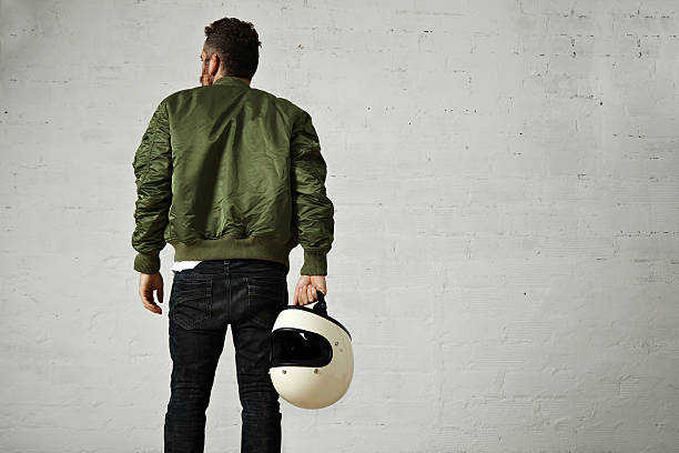 istock Man in a khaki pilot jacket with helmet 621364270
