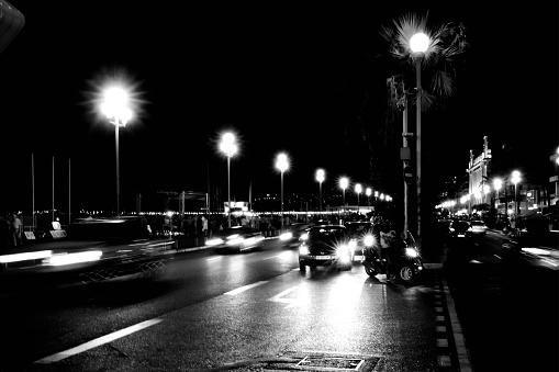 Nice, France - July 31, 2015: The promenade in Nice at night with traffic heading towards the camera with blurred motion.