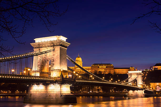 beleuchteter blick auf die kettenbrücke in budapest bei nacht - chain bridge budapest night bridge stock-fotos und bilder