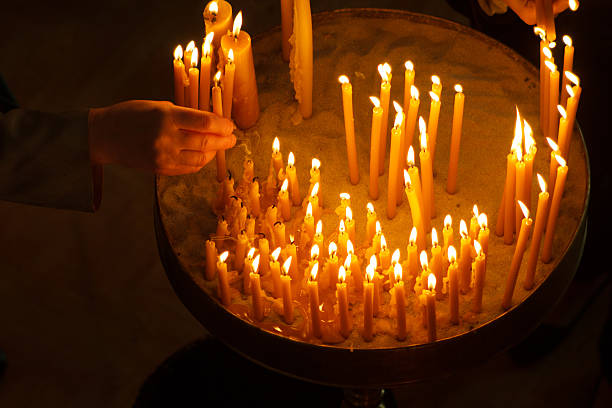 istock Burning candles with hand holding candle 621365782