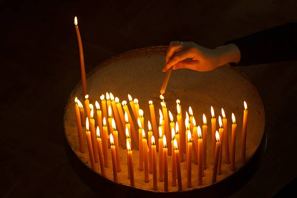 istock Burning candles with hand holding candle 621365816