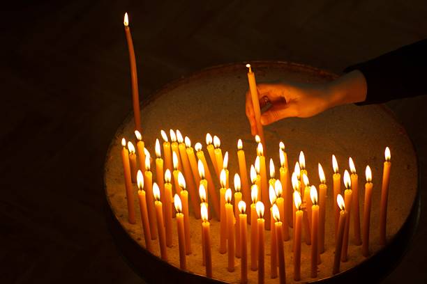 Burning candles with hand holding candle