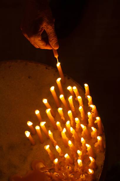 istock Burning candles with hand holding candle 621365902