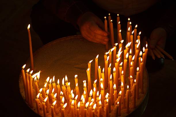 istock Burning candles with hand holding candle 621365948