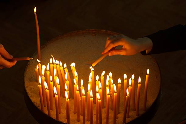 istock Burning candles with hand holding candle 621366070