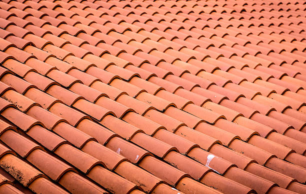 istock Red roof tiles or shingles on house as background image. 621366440