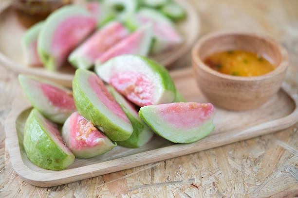 istock Ripe guava fruit cut with sweet sauce. Selective focus 621366888