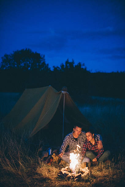 istock Couple preparing sausages on bonfire 621367810