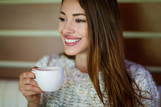 istock Beautiful woman drinking coffee 621369364