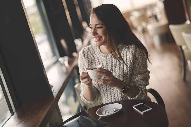 istock Beautiful woman drinking coffee 621369448