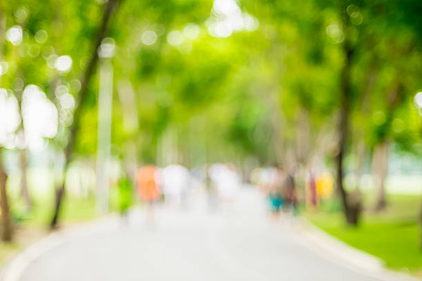 istock Blurred background,People exercise at green park with bokeh ligh 621369452