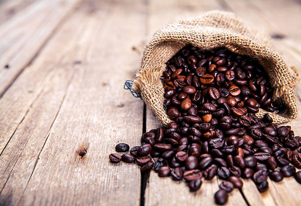 istock Coffee beans on the wooden background. Hot drinks. 621370098