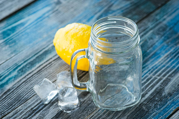istock Glass jar and melted ice cubes with citrus fruits 621370614