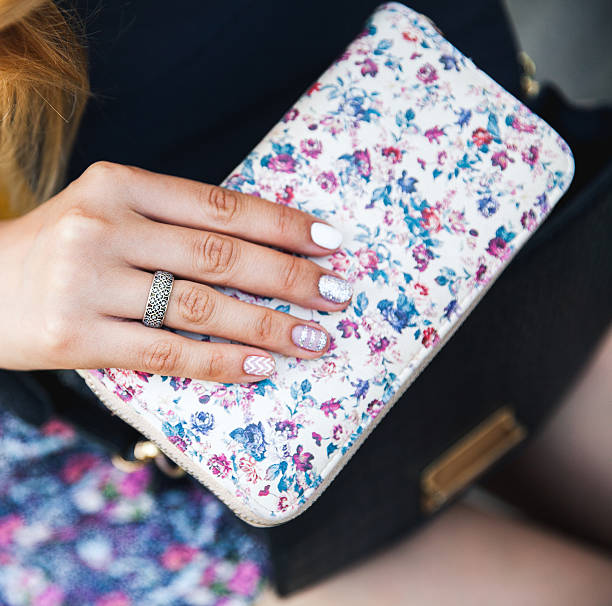 istock Beautiful female hands with manicure hold handbag 621371446