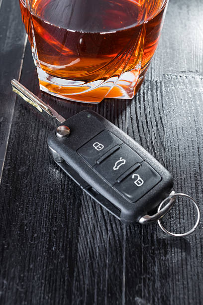 istock Car key and whiskey alcohol drink in a glass on 621371802