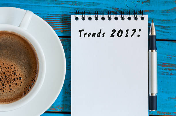istock Trends 2017 written at notepad on blue table workplace near 621372990