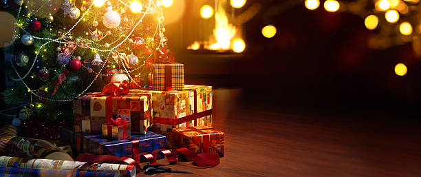 istock Christmas tree and holidays present on fireplace background 621374074