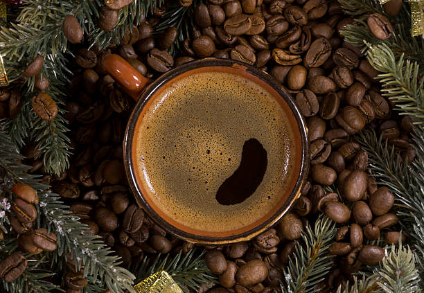 istock Cup of black coffee, beans, spruce branches, decor 621374114