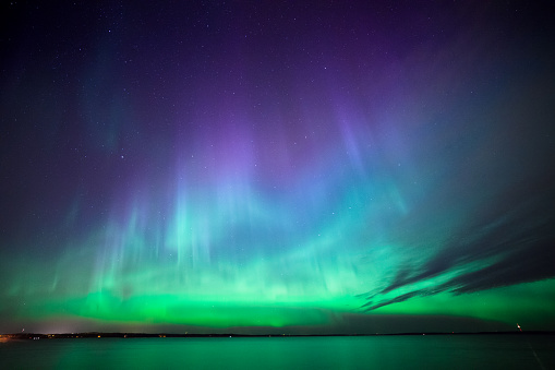 Beautiful northern lights aurora borealis over lake in finland