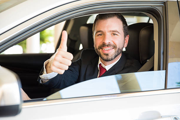 istock Man driving car and giving a thumb up 621375750
