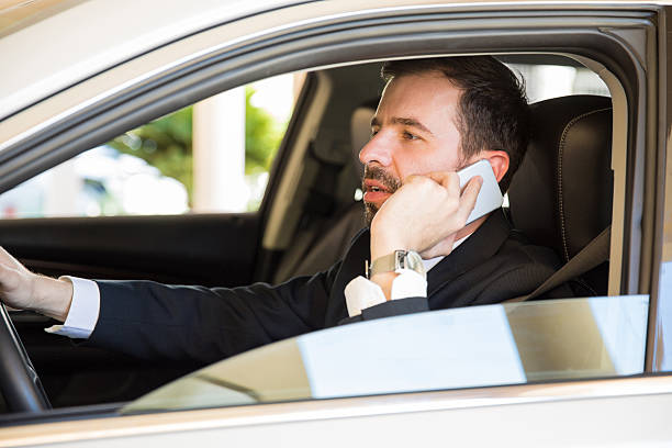 istock Businessman driving and talking on a phone 621375814