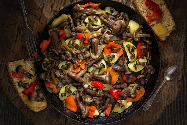 istock Mushrooms fried with onions and potatoes in the pan. 621377032