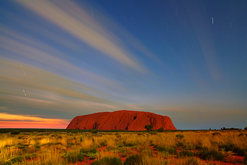Northern Territory, Australia - May 18, 2011: Long exposure of Uluru in Australia's Northern Territory. Sunrise is some way off, and the great sandstone monolith is lit by moonlight.