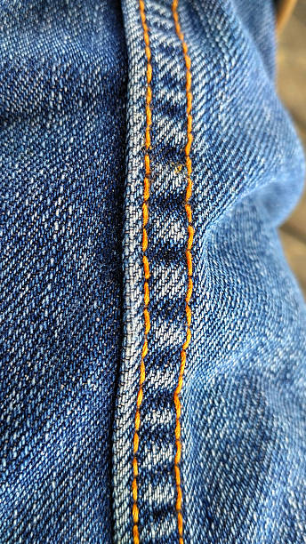 istock seen yellow stitching of the blue jeans 621377496