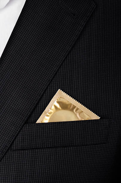 istock condom in the pocket suit jacket close-up vertical 621377572