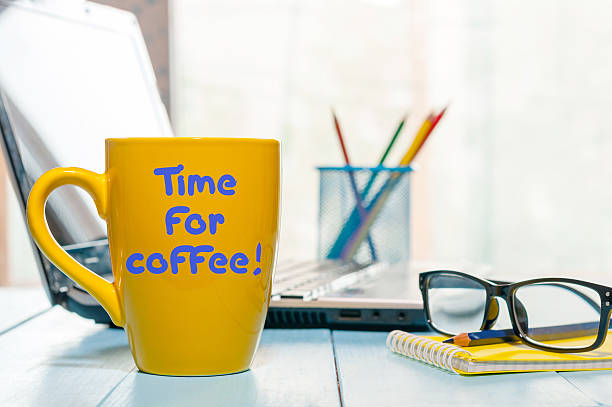 istock Time for coffee written on yellow cup at business office 621378516