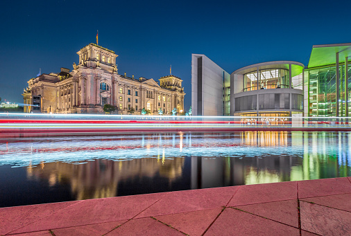 Panoramic view of Berlin government district with famous Reichstag building, seat of the German Parliament (Deutscher Bundestag), and Paul Lobe Haus in twilight during blue hour at dusk, Berlin, Germany