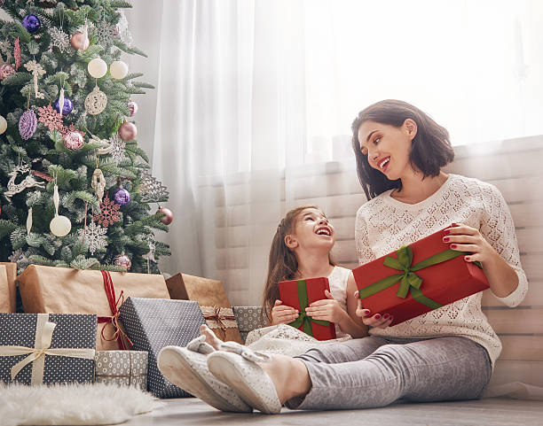 istock Mother and daughter exchanging gifts 621379360