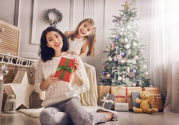 istock Mother and daughter exchanging gifts 621379902