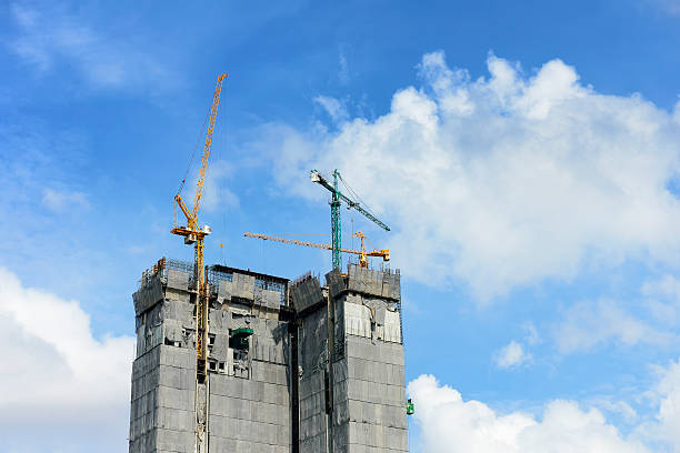 istock under construction building with the crane and the sky. 621380046