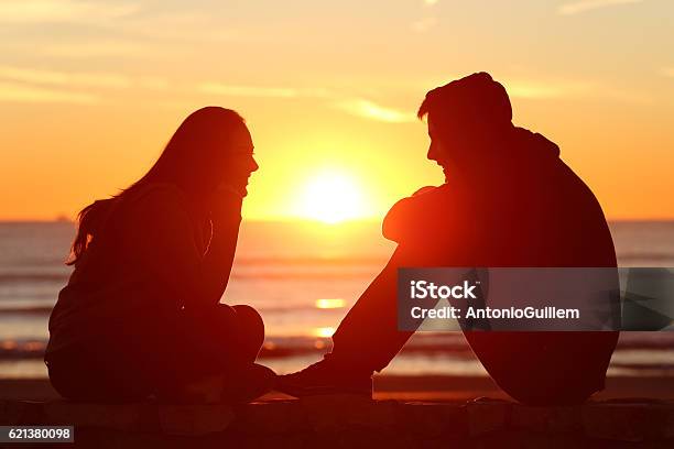Friends Or Couple Of Teens Facing At Sunset Stock Photo - Download Image Now - Love At First Sight, Couple - Relationship, Teenager